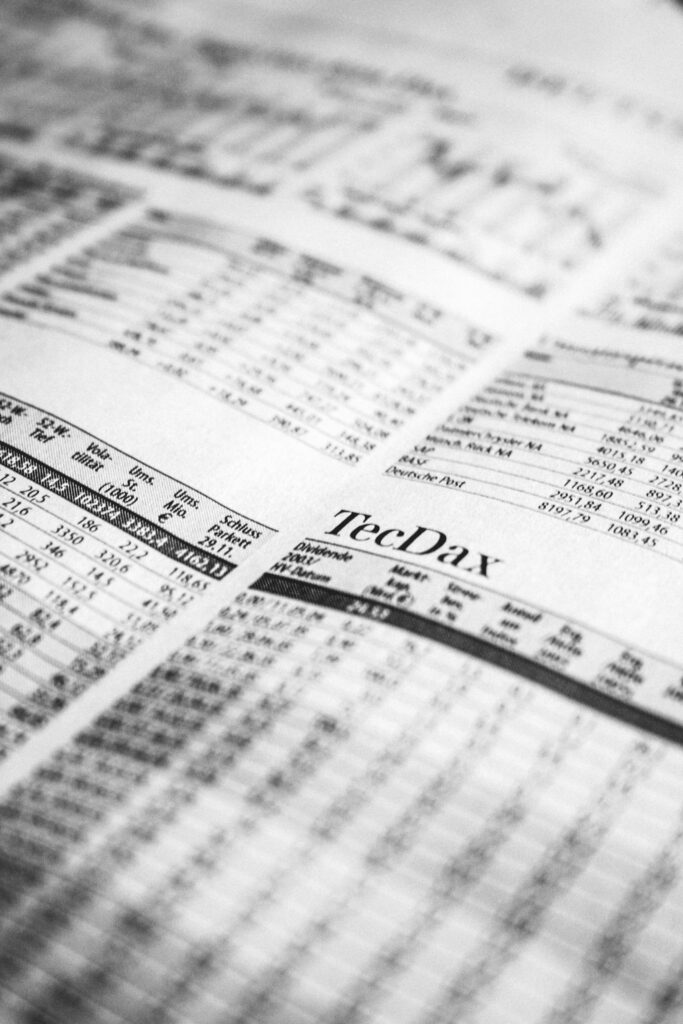 Close-up of a printed stock market report in black and white, highlighting stock prices.